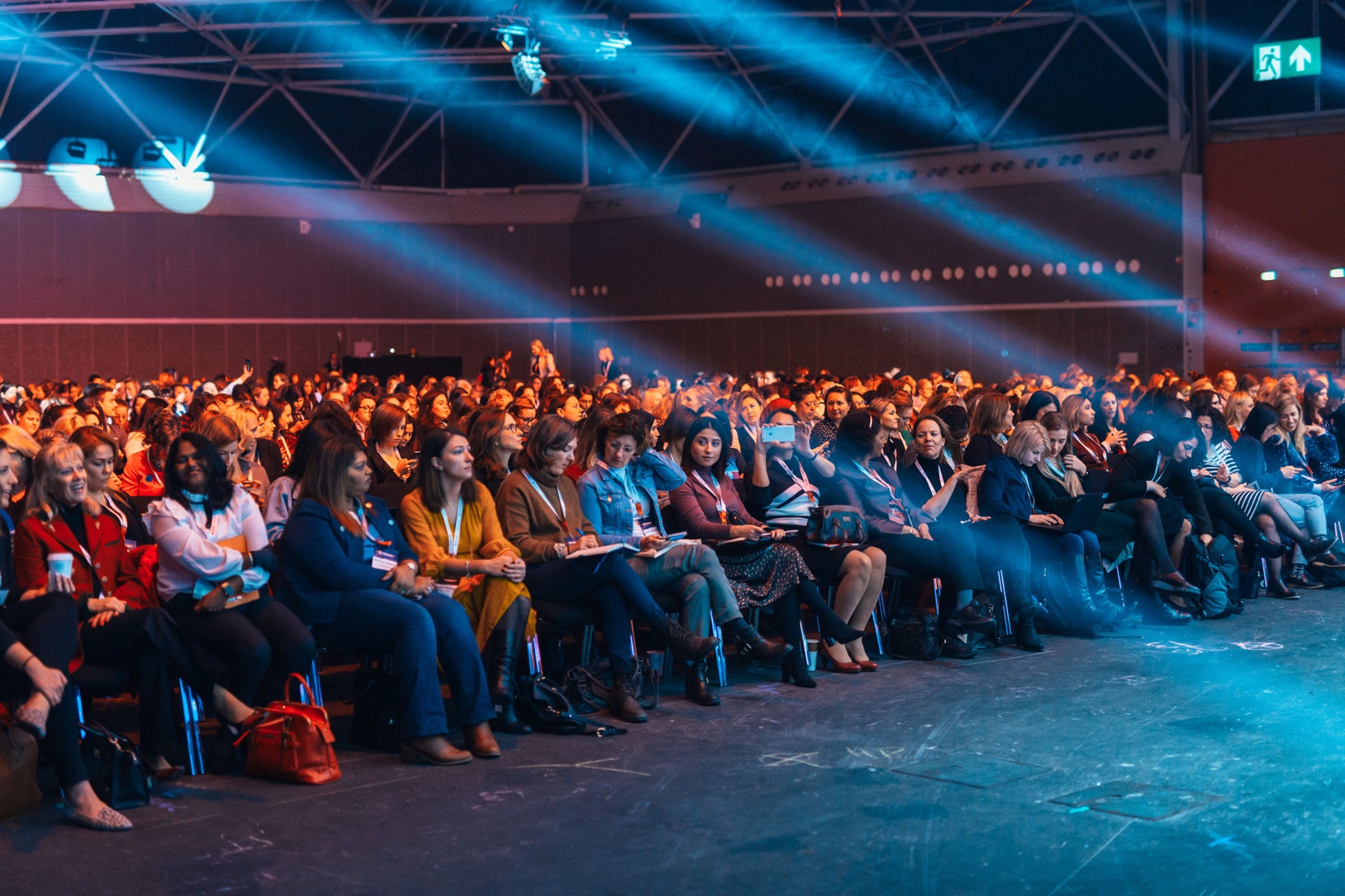 A conference audience seated before a presentation